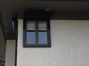 Wilmington electric hurricane shutter on stucco window.