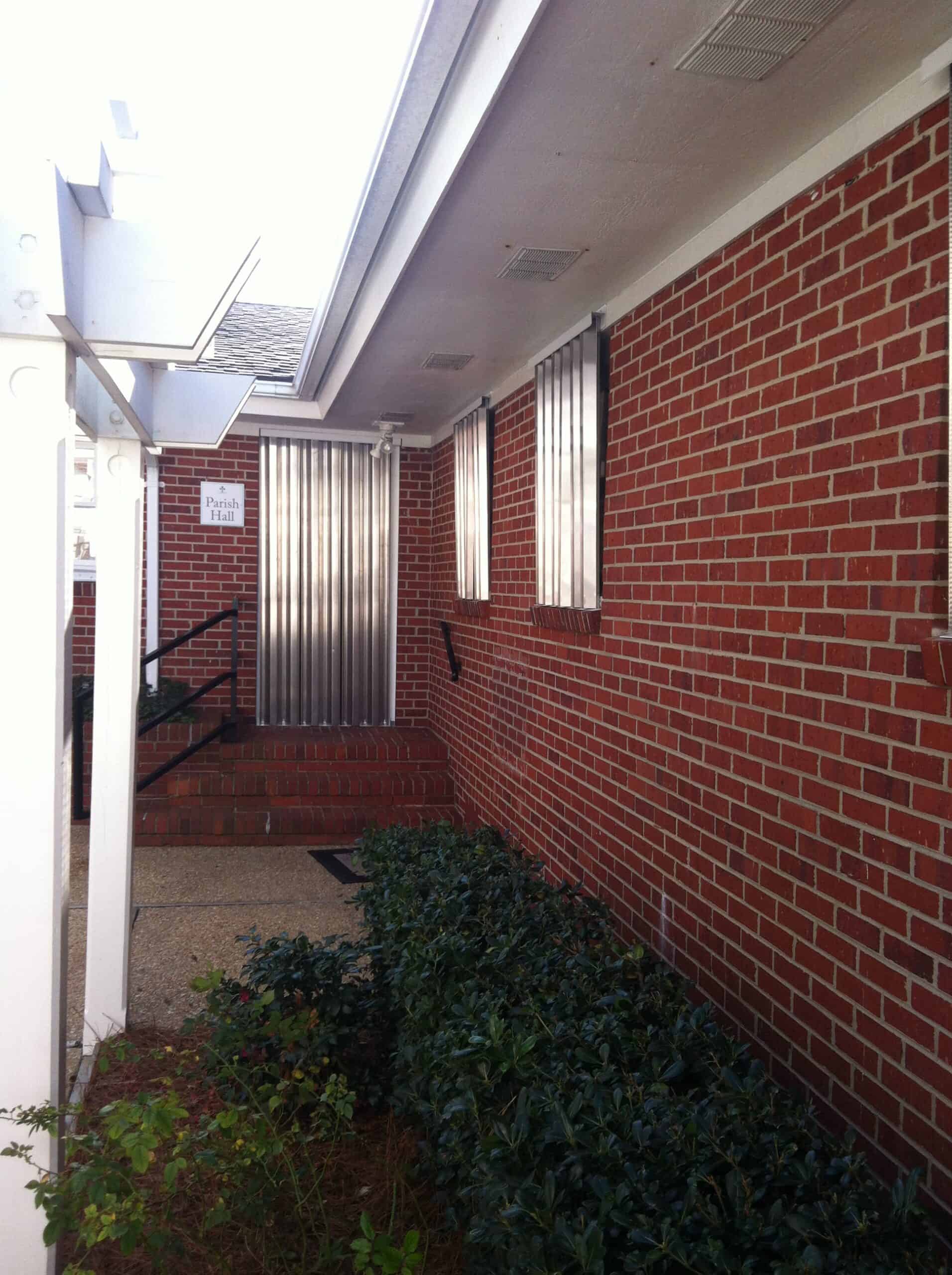 Close-up of hurricane storm panel track system and corrugated aluminum panel