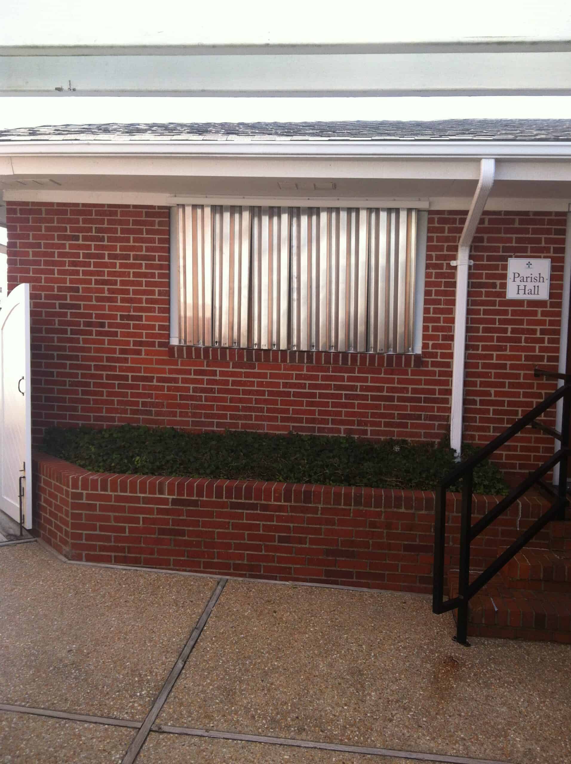 Aluminum hurricane panels installed on a two-story coastal home in North Carolina
