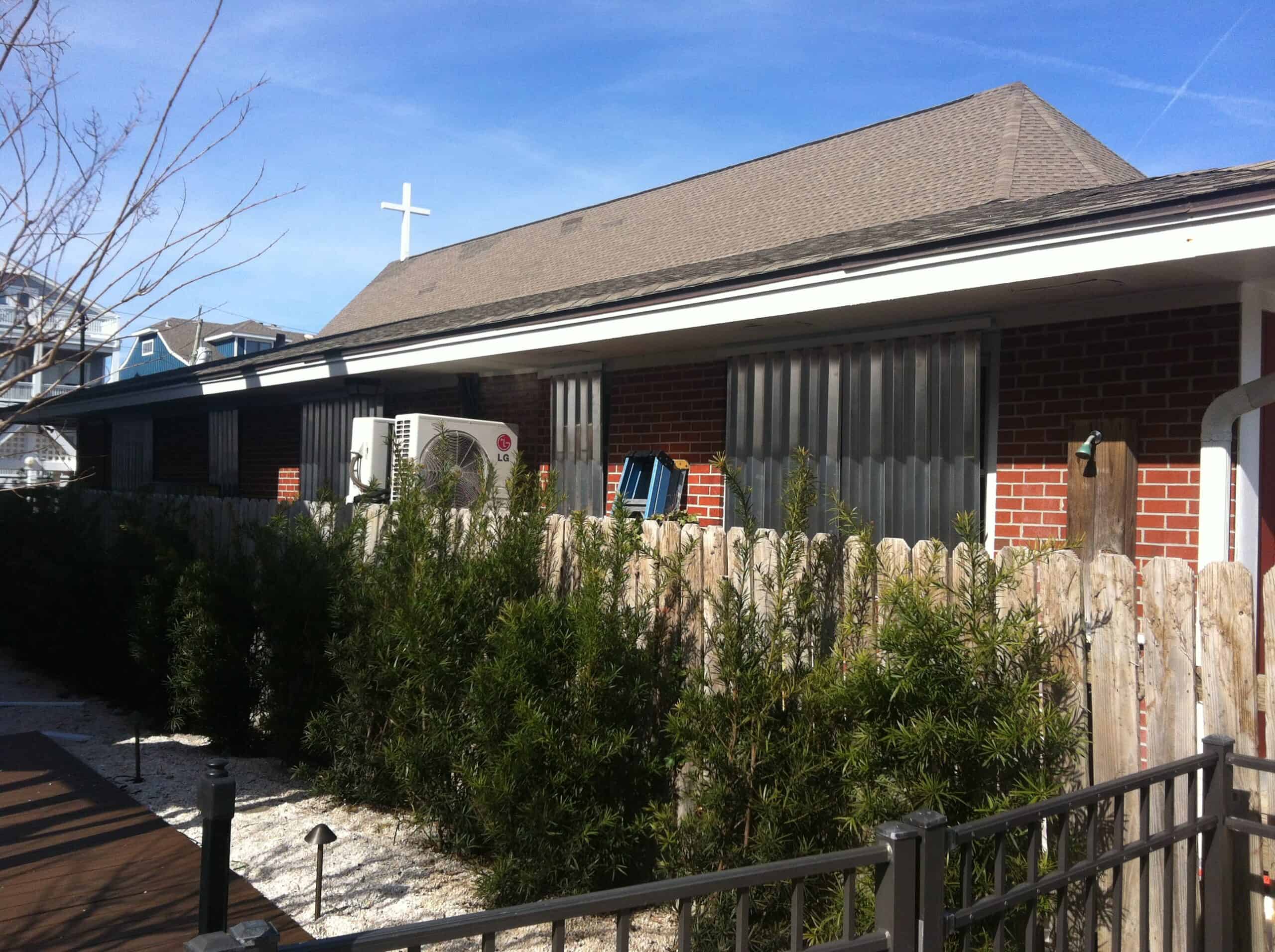 Full-coverage hurricane storm panels installed on all openings of a coastal NC home