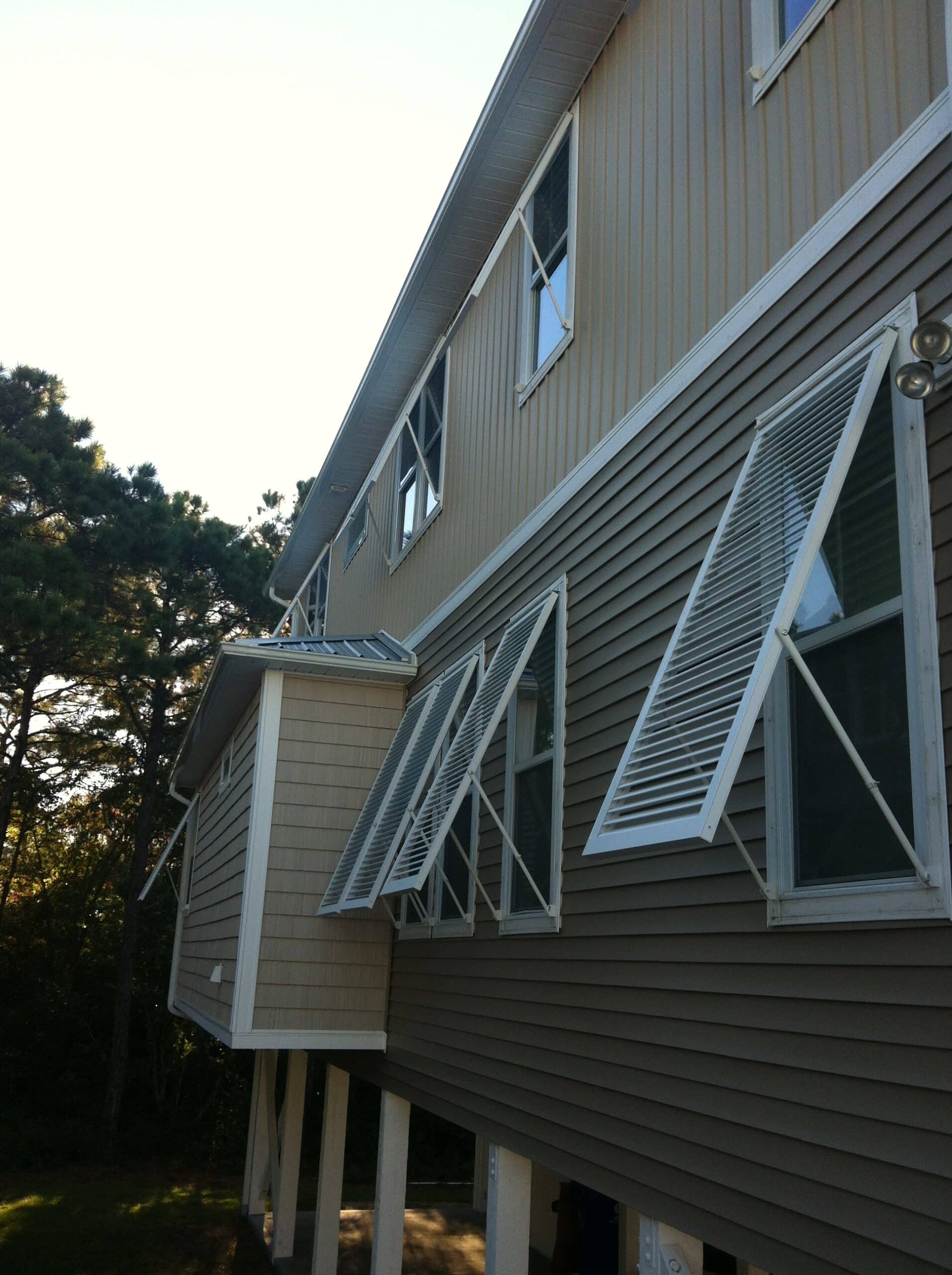 Bahama shutters propped open on a Carolina coast home showing daily shade function