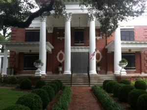 Stately Carolina red brick mansion featuring white columns.