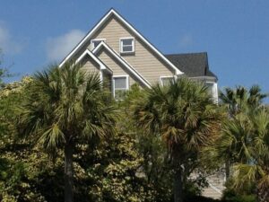 Serene tropical house, hurricane shutters, lush palms, Wilmington NC.