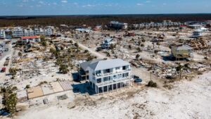 Myrtle Beach hurricane aftermath: intact elevated house, coastal devastation.