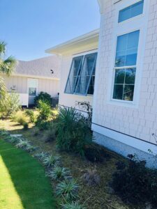 Wilmington coastal home with Bahama hurricane shutters.