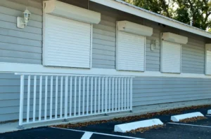 Wilmington commercial building with white roll-down hurricane shutters.