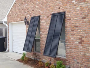 Wilmington brick house with angled hurricane shutters.