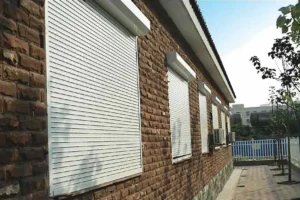 Wilmington NC brick building with white rolldown hurricane shutters.