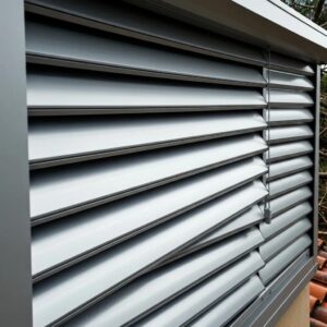 Close‑up of a heavy‑duty aluminum roll‑down shutter with blurred storm debris behind, demonstrating impact resistance