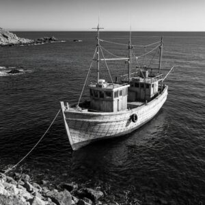 Coastal home with roll down hurricane shutters being cleaned, showcasing the importance of maintenance