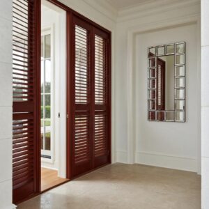 Home with accordion shutters installed, showcasing hurricane protection features
