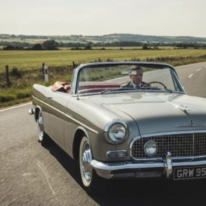 Installer measuring for roll‑down hurricane shutters on a coastal home to ensure a precise fit