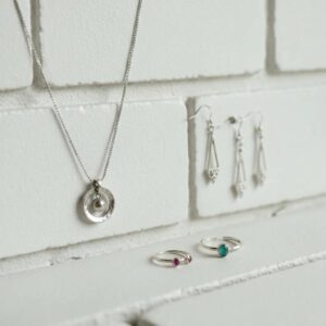 Selection of trending accordion shutter colors for 2024 against a coastal backdrop