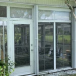 White accordion hurricane shutters installed on a canal home in Ocean Isle Beach NC.