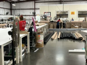 Hurricane Shutter Installers Wilmington NC American Hurricane Shutters truck and manufacturing line parked inside our facility near the Cape Fear Riverwalk in Downtown Wilmington NC.