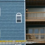 Corrugated aluminum storm panels stacked and ready for deployment on a Surfside Beach rental