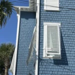 Tropical Bahama storm shutters providing shade on a waterfront home in Little River SC.