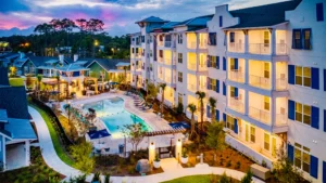 A multi-story commercial building in Myrtle Beach featuring custom-designed, angled perforated metal storm panels installed by American Hurricane Shutter.