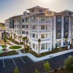 Black Colonial hurricane shutters installed on a historic senior living home in Conway SC.