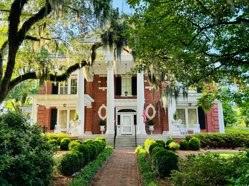 Colonial hurricane shutters on a New Bern, NC home offering Crystal Coast hurricane protection by AHS. Enhance your