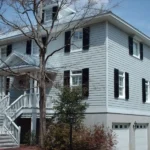 Black Colonial hurricane shutters installed on a historic brick home in Downtown Wilmington NC.