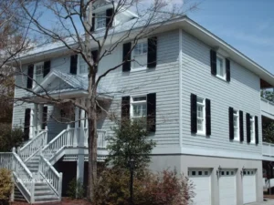Black Colonial hurricane shutters installed on a historic brick home in Downtown Wilmington NC.