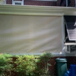 Motorized hurricane screens protecting a golf course lanai in Porters Neck Country Club.