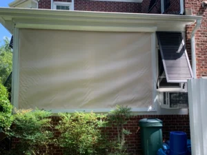 Motorized hurricane screens protecting a golf course lanai in Porters Neck Country Club.